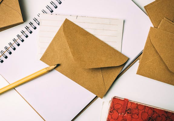 Brown envelope on white notepad